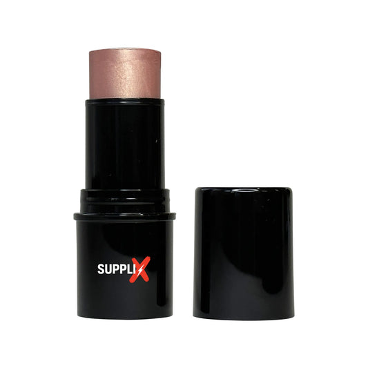 Shimmering Beige Lights highlighter stick gliding on cheekbones, delivering vitamin C-powered radiant glow and silky smooth, 