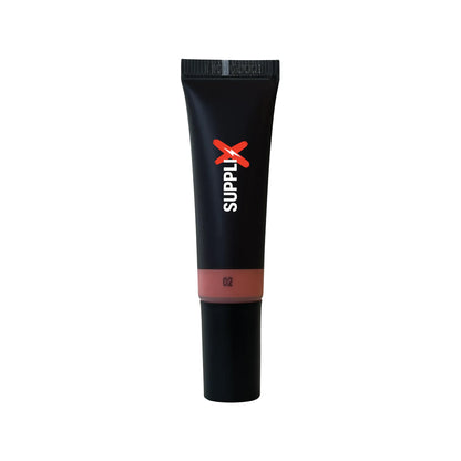 Close-up of SUPPLI-X Liquid Blush Dew Peach bottle with shimmering peach tint drops on skin, highlighting vegan, blendable fo